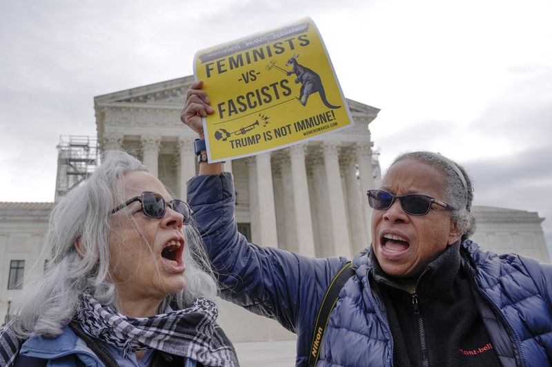 Demonstrators protest outside the Supreme Court as the justices prepare to hear arguments over whether Donald Trump is immune from prosecution in a case charging him with plotting to overturn the results of the 2020 presidential election, on Capitol Hill Thursday, April 25, 2024, in Washington. (AP Photo/Mariam Zuhaib)
