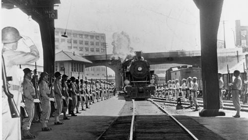 April 1945 -- An armed guard from Camp Sibert presents arms as the special funeral train bearing the body of President Roosevelt pulls into Atlanta's Terminal Station on its way from Warm Springs, Ga., to Washington, D.C.