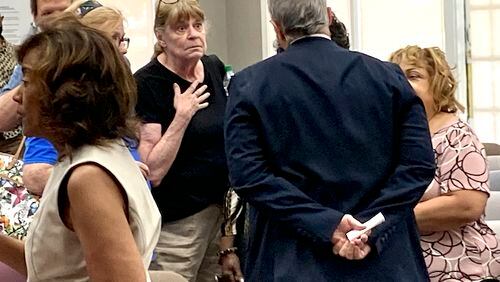 Attendees confronted Fayette County Commissioner Chuck Oddo after the board voted Thursday to hire a law firm to draft redistricting maps. Jill Howard Church for the AJC