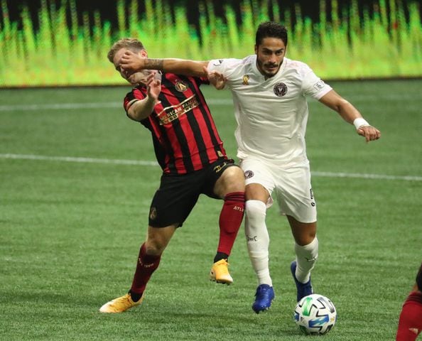 Atlanta United forward Jon Gallagher (26) gets a hand to the face from Miami defender Nicolas Figal (5) as they battle for the ball in the first half at Mercedes-Benz Stadium Saturday, September 19, 2020 in Atlanta.  JASON GETZ FOR THE ATLANTA JOURNAL-CONSTITUTION