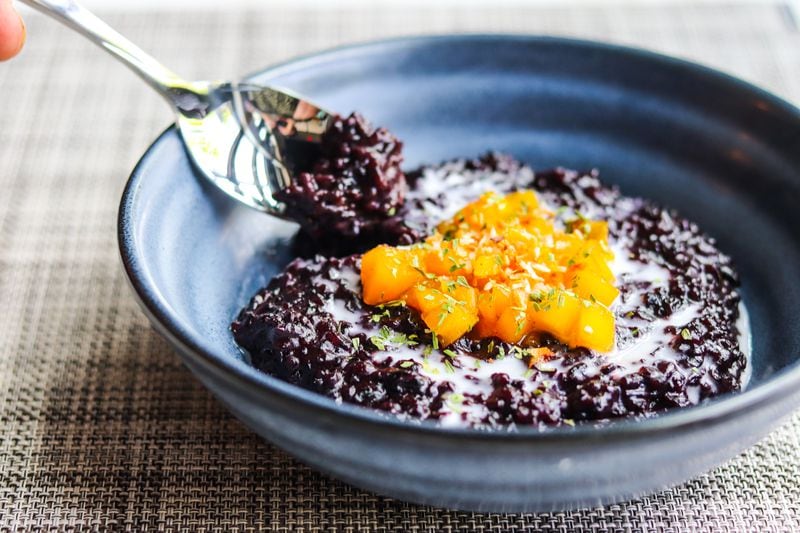 Rice pudding features black rice, cooked in coconut milk and topped with whiskey-poached peaches and coconut flakes. Courtesy of Tori Allen PR