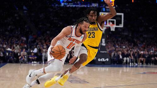 New York Knicks' Jalen Brunson (11) drives past Indiana Pacers' Aaron Nesmith (23) during the first half of Game 1 in an NBA basketball second-round playoff series, Monday, May 6, 2024, in New York. (AP Photo/Frank Franklin II)