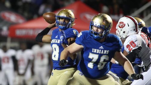 McEachern quarterback Carlos Del Rio (8) attempts a pass as center Taylor Hogan (76) blocks in the first half against North Gwinnett in the Class 7A quarterfinals at McEachern High School Friday, November 29, 2019 in Powder Springs, Ga. Del Rio left McEachern for Grayson but was declared ineligible Tuesday. (JASON GETZ/SPECIAL TO THE AJC)