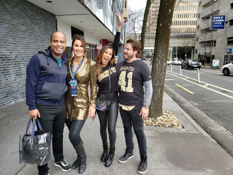 New Orleans Saints fans show out in downtown Atlanta before the Super Bowl. Rodger Smith (left) and wife Napoli-Smith (second to left) and family have tickets to the game.