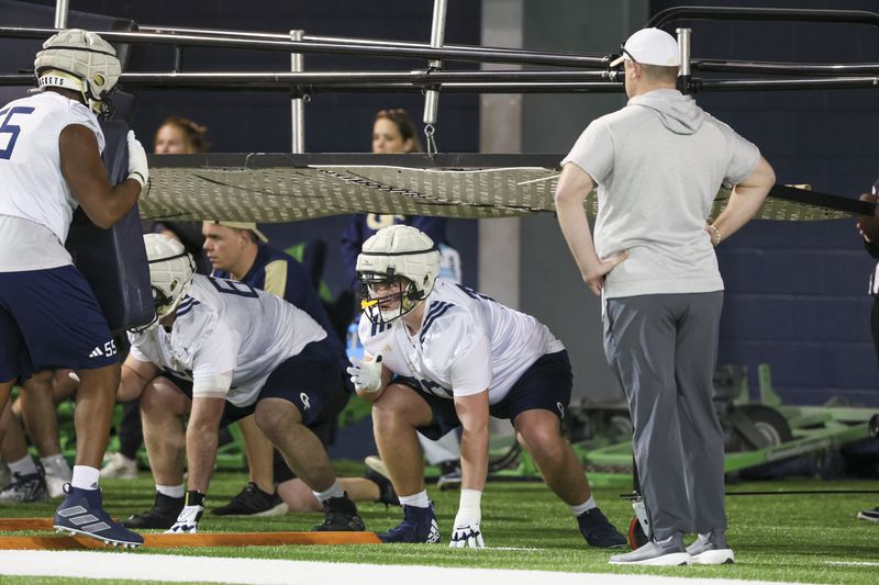 Georgia Tech coach Bent Key watches as offensive lineman Jameson Riggs (70) and others participate in a drill during their first day of spring football practice at the Brock Indoor Practice Facility, Monday, March 11, 2024, in Atlanta. (Jason Getz / jason.getz@ajc.com)