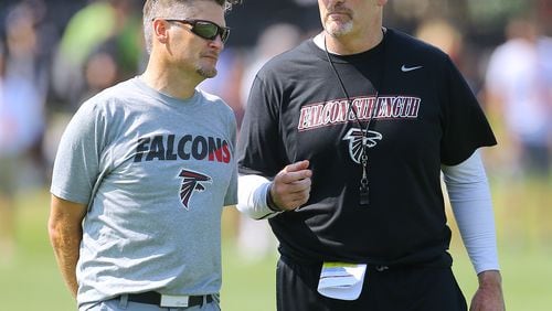 Falcons General Manager Thomas Dimitroff and head coach Dan Quinn confer on the first day of training camp on Friday, July 31, 2015, in Flowery Branch.  Curtis Compton / ccompton@ajc.com