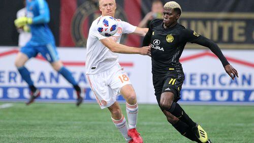 August 19, 2018 Atlanta: Atlanta United midfielder Jeff Larentowicz and Columbus Crew forward Gyasi Zardes battle for the ball during the second half in a MLS soccer match on Sunday, August 19, 2018, in Atlanta.  Curtis Compton/ccompton@ajc.com