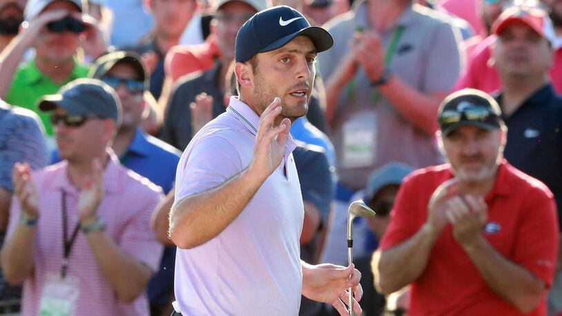 Masters leader Francesco Molinari waves to the patrons after his bunker shot to the 18th green on his way to save par and finish at 13-under at Augusta National Golf Club on Saturday, April 13, 2019, in Augusta.    Curtis Compton/ccompton@ajc.com