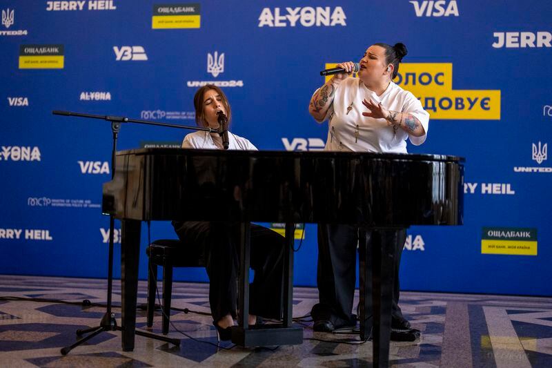 Ukrainian singer Jerry Heil, left, and rapper alyona alyona perform a song in Kyiv, Ukraine, Thursday, April 25, 2024. Ukraine’s entrants in the pan-continental music competition, the female duo of rapper alyona alyona and singer Jerry Heil set off from Kyiv for the competition on Thursday. In wartime, that means a long train journey to Poland, from where they will travel on to next month’s competition in Malmö, Sweden. (AP Photo/Francisco Seco)