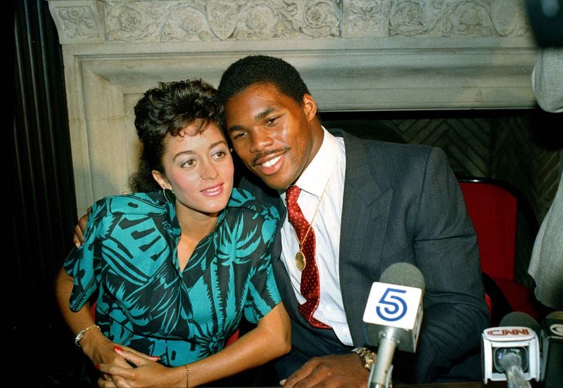 New Jersey Generals running back Herschel Walker poses with his wife, Cindy, after announcing he will play for the Dallas Cowboys during a 1986 press conference. The two divorced in 2002. (AP Photo/Marty Lederhandler)