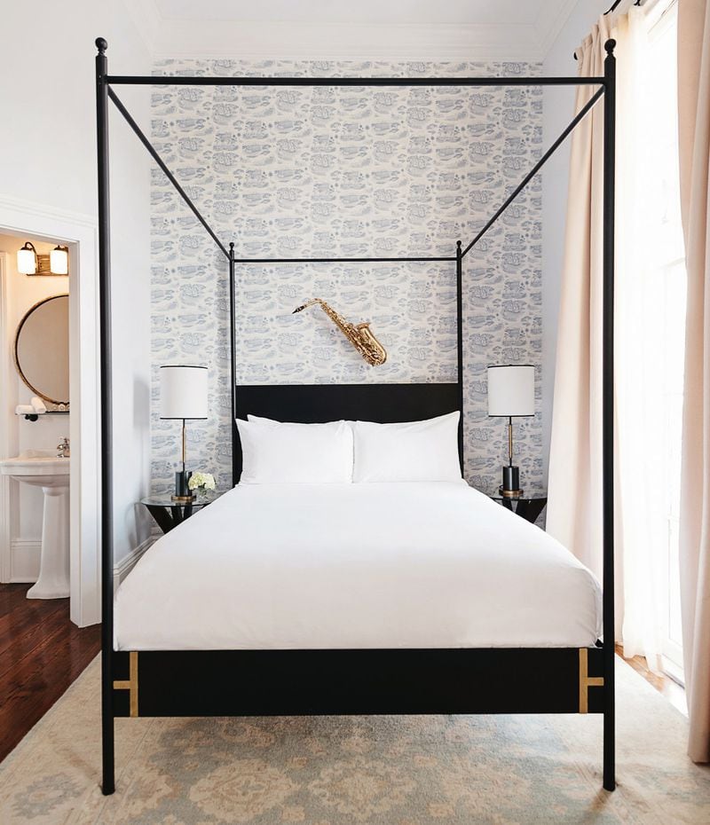 Crafted in New Orleans by Doorman Designs, the Josephine canopy bed features a solid steel headboard and brass accents. 