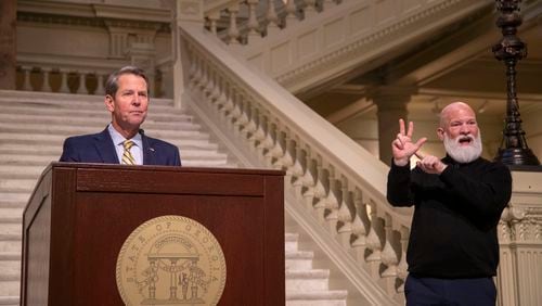 David Cowan, right, All Hands On American Sign language deaf interpreter, interprets as Governor Brian Kemp gives remarks during a COVID-19 update press conference at the Georgia State Capitol Building in Atlanta, Thursday, January 21, 2021. (Alyssa Pointer / Alyssa.Pointer@ajc.com)