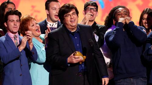 FILE - Dan Schneider, center, accepts an award in Los Angeles. Schneider sued the makers of “Quiet on Set: The Dark Side of Kids TV” on Wednesday, May 1, 2024, alleging the makers of the documentary series wrongly implied that he sexually abused the child actors he worked with. (Photo by Matt Sayles/Invision/AP, File)