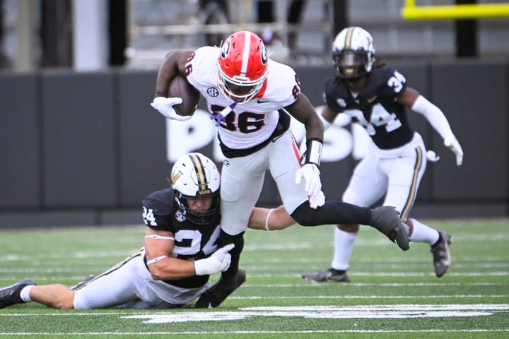 Georgia wide receiver Dillon Bell (86) is brought down by Vanderbilt linebacker Nicholas Rinaldi (24) during the second half of an NCAA football game against Vanderbilt, Saturday, Oct. 14, 2023, in Nashville, Tenn. Georgia won 37-20. (Special to the AJC/John Amis)