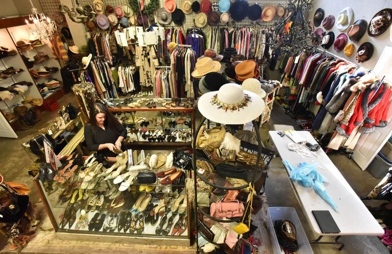 December 2, 2016 Atlanta - Christy Ogletree Ahlers, owner of Peachtree Battle Estate Sales and Liquidations, prepares for the estate sale of Diane McIver's wardrobe next week as she is surrounded by more than 2,000 of Diane McIver's clothing and jewelry items in a warehouse showroom at Peachtree Battle Estate Sales and Liquidations on Friday, December 2, 2016. More than 2,000 of her articles of clothing, jewelry, hats and shoes are on display. Tex McIver has enlisted an estate liquidation company to sell more than 2,000 of his deceased wife's clothing and jewelry items. HYOSUB SHIN / HSHIN@AJC.COM