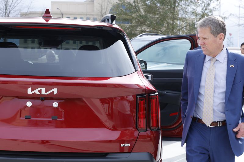 Gov. Brian Kemp admires a Kia vehicle on the first ever Kia Day at the State Capitol on Tuesday, January 31, 2023. (Natrice Miller/The Atlanta Journal-Constitution) 