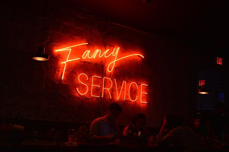Bon Ton’s main dining room features a large neon sign reading “Fancy Service.” CONTRIBUTED BY HENRI HOLLIS