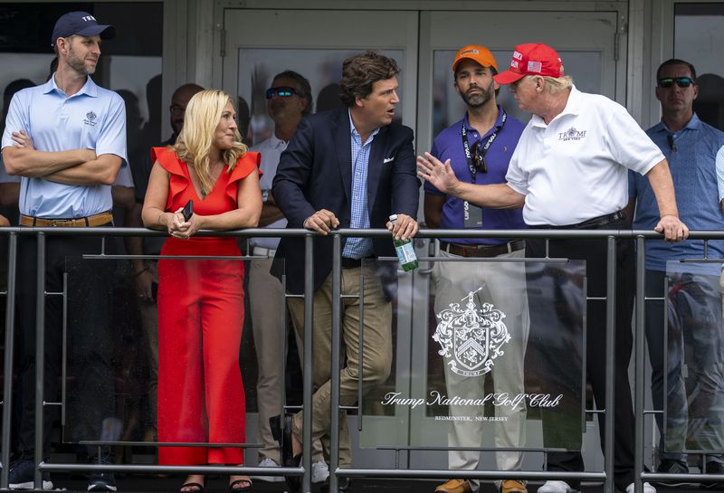  Eric Trump, Rep. Marjorie Taylor Greene (R-Ga.), Tucker Carlson, Donald Trump Jr. and former President Donald Trump at Trump National Golf Club in Bedminster, N.J., July 31, 2022. Carlson recently aired video footage of the Jan. 6, 2021 attack on the U.S. Capitol. (Doug Mills/The New York Times)