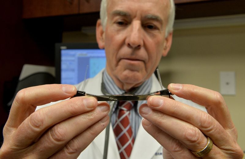 Dr. Stanley Fineman, an allergist with Atlanta Allergy & Asthma, shows the device used to collect pollen samples. AJC FILE PHOTO 2016