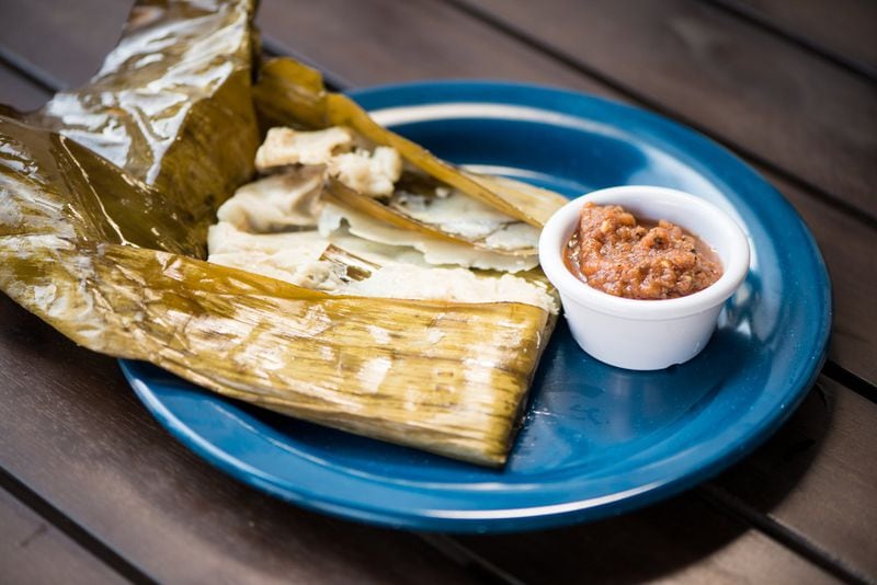  Tomatillo Tamales, corn masa filled with chicken, tomatillo sauce, and grilled jalapeno steamed in a banana leaf. Photo credit- Mia Yakel.