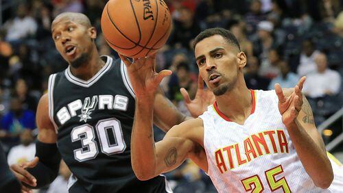 101415 ATLANTA: Hawks guard Thabo Sefolosha, playing in a game for the first time since being injured in a Manhattan night club last season, rebounds against Spurs forward David West during the first period in their preseason basketball game on Wednesday, Oct. 14, 2015, in Atlanta. Curtis Compton / ccompton@ajc.com