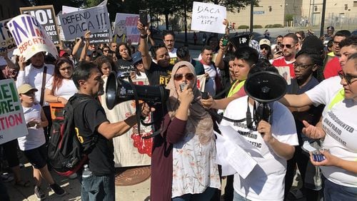 Aisha Yaqoob, center with microphone, was among hundreds of activists who demonstrated outside the Atlanta City Detention Center Monday, Sept. 4, 2017, in favor of the Deferred Action for Childhood Arrivals program. The policy director for Asian Americans Advancing Justice Atlanta, Yaqoob told the demonstrators. “Please stand with me and make sure you are demanding our representatives in Congress are taking the best steps necessary to make positive and meaningful legislation to protect all of our immigrant communities today.” Jeremy Redmon/jredmon@ajc.com