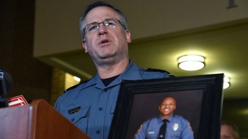 Chief Butch Ayers speaks to the media outside Gwinnett County Police Department Headquarters in Lawrenceville on Saturday, October 20, 2018. Officer Antwan Toney, shown in the photo that Ayer is holding, was shot when he approached a “suspicious vehicle” that was reported to police. Toney died later at Gwinnett Medical Center. (Photo: HYOSUB SHIN / HSHIN@AJC.COM)
