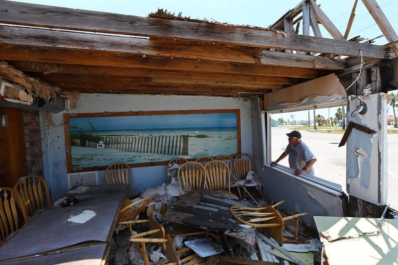 Mexico Beach Mayor Al Cathey looks over the remains of the Fish House Restaurant that stood beside his devastated hardware store seven months after Hurricane Michael hit Mexico Beach in Florida. Only three restaurants have reopened in town, two working from mobile units. A photograph of the town’s classic beach, which lost all the sand dunes, hangs on the wall. 