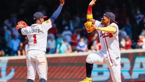 Atlanta Braves outfielder Ronald Acuña Jr. (13) and ] second baseman Ozzie Albies (1) celebrate after the Braves swept the series against the Arizona Diamondback with a 5-2 win at Truist Park on Sunday, April 7, 2024. 
Miguel Martinez / miguel.martinezjimenez@ajc.com 