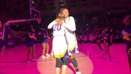 Deasia Merrill (right) is greeted by teammate Hannah Goen (No. 20) during introductions for the state championship game.