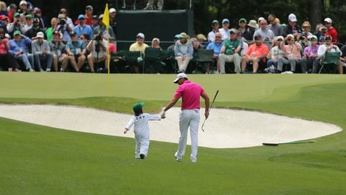 Jason Day walks to the 5th green holding hands with his son Dash during the Par 3 Contest at Augusta National Golf Club on Wednesday, April 6, 2016, in Augusta. (Curtis Compton/ccompton@ajc.com)