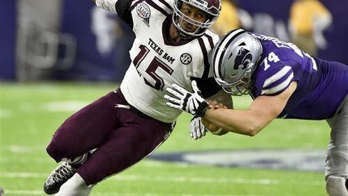 In this Dec. 28, 2016, file photo, Texas A&M’s Myles Garrett (15) tries to get around Kansas State offensive lineman Scott Frantz during the second half of the Texas Bowl NCAA college football game in Houston.The NFL Draft will be held April 27-29, 2017, in Philadelphia. (AP Photo/Eric Christian Smith, File)