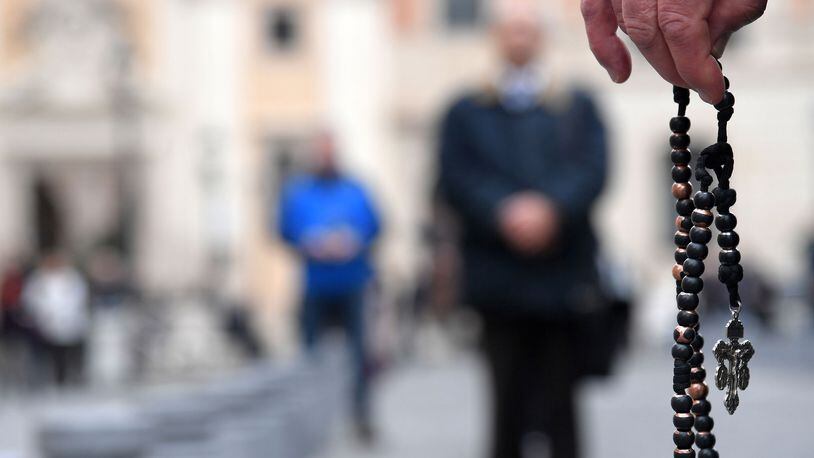 Members of an international coalition of lay people known as "Acies Ordinata", one holding a rosary during a demonstration in Piazza San Silvestro in downtown Rome on February 19, 2019, to denounce what they call a "Wall of Silence" regarding child sexual abuse within the Catholic Church worldwide. (Tiziana Fabi/AFP/Getty Images/TNS)