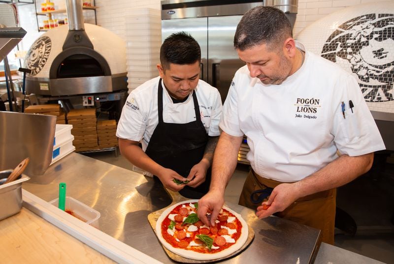 Chef Anthony Infante (left) works alongside Minnie Olivia Pizzeria owner Julio Delgado. When the pandemic forced restaurants to close their dining rooms in March 2020, Infante agreed to stay and help Delgado weather the crisis. (RYAN FLEISHER FOR THE ATLANTA JOURNAL-CONSTITUTION)