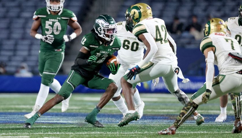 Dec. 30, 2020 - Atlanta, Ga: Collins Hill wide receiver Travis Hunter (12) runs after a reception against Grayson linebacker Franklin Neal (42) during the first half of their Class 7A state high school football final at Center Parc Stadium Wednesday, December 30, 2020 in Atlanta. JASON GETZ FOR THE ATLANTA JOURNAL-CONSTITUTION