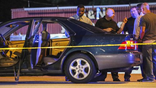 DeKalb police work the scene of a reportedly gang-related shooting that killed a teen girl in August. JOHN SPINK /JSPINK@AJC.COM