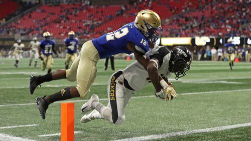 Colquitt County wide receiver Lemeke Brockington (17) makes a touchdown catch against McEachern defensive back Ja'Leak Perry (12) in the second half during the Corky Kell Classic at Mercedes-Benz Stadium Saturday, August 18, 2018, in Atlanta. Colquitt County won 41-7. PHOTO / JASON GETZ