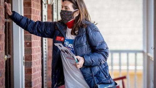 Claudia Eisenburg knocks on the door of a Peachtree City house while canvassing the neighborhood on Dec. 14, 2020. (Steve Schaefer for The Atlanta Journal-Constitution)