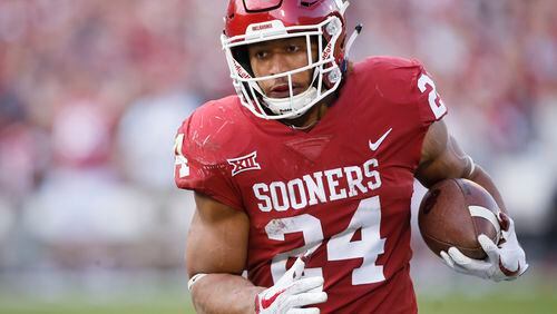 Oklahoma running back Rodney Anderson (24) carries in the second quarter of an NCAA college football game against West Virginia in Norman, Okla. Anderson, one of Oklahoma's breakout stars this year, is accused of sexual assault. (AP Photo/Sue Ogrocki, File)