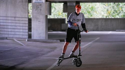 L.H. Couch, a 76-year-old retired IT executive, rides his exercise Trikke on a virtually empty level of a parking deck beside once-bustling Sandy Spring office towers. Many office employees are still working from home, in what started as temporary moves after the coronavirus pandemic hit locally. Some employers are making changes as short-term job rearrangements have grown long term. JOHN AMIS FOR THE ATLANTA JOURNAL-CONSTITUTION