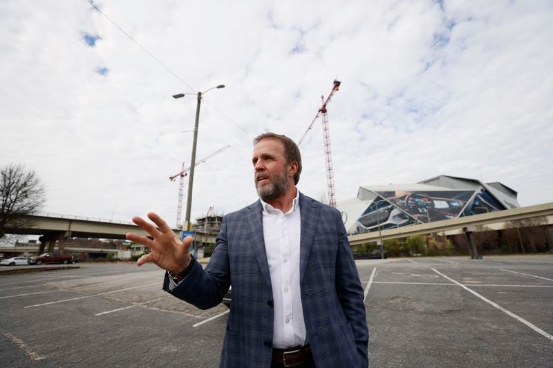 Brian McGowan, President of Centennial Yards, stands by the parking lot known as “The Gulch,” which will become a massive construction site by mid-2024. The project, which will include four buildings totaling more than 500,000 square feet of space, is expected to make major strides before the World Cup in 2026.
Miguel Martinez /miguel.martinezjimenez@ajc.com