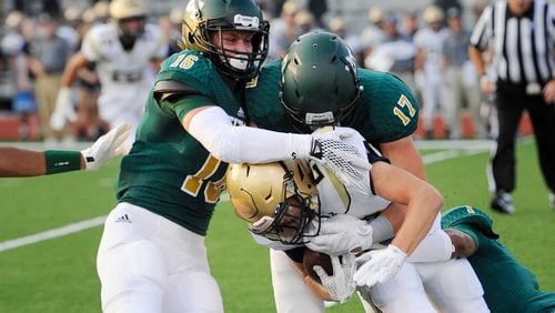 J.D. Bertrand (16) tackles St. Pius running back Harrison Bernhardt in a 2015 contest. Bertrand, now a 4-star senior linebacker, recently decommited from the University of Georgia.