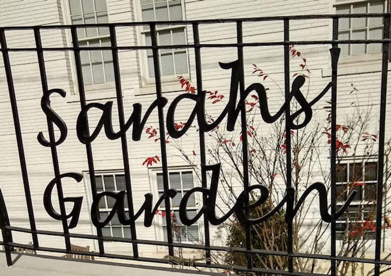 'Sarahs' Garden' sign was installed on the railing along East Wesley above the garden, announcing to passers by that there is a garden below.  Courtesy of Jane Brann and Respite Care Atlanta  

