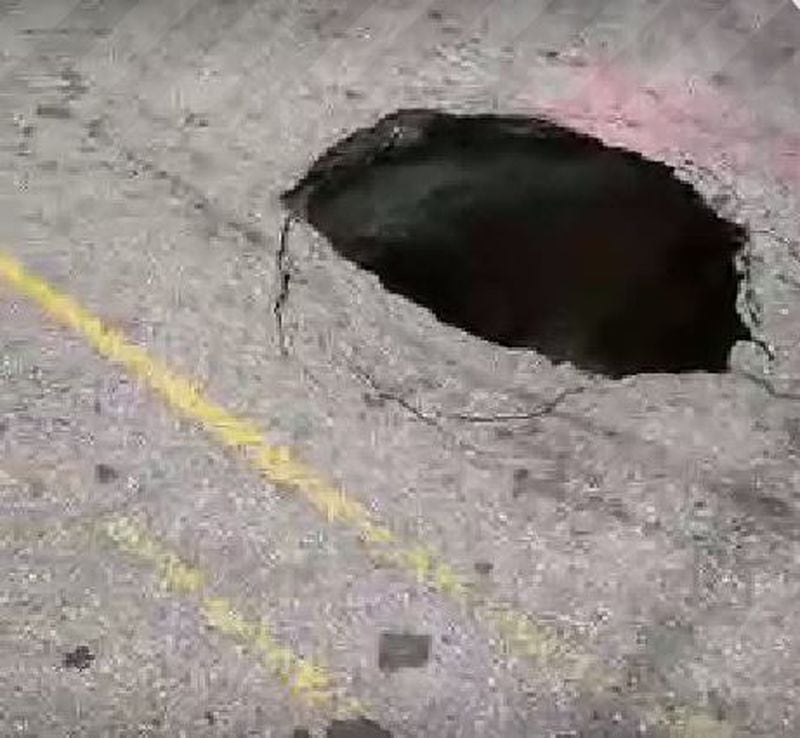 A small sinkhole has prompted closure of Fifth Street near West Peachtree Street. (Credit: Twitter / Georgia Tech Police Department)