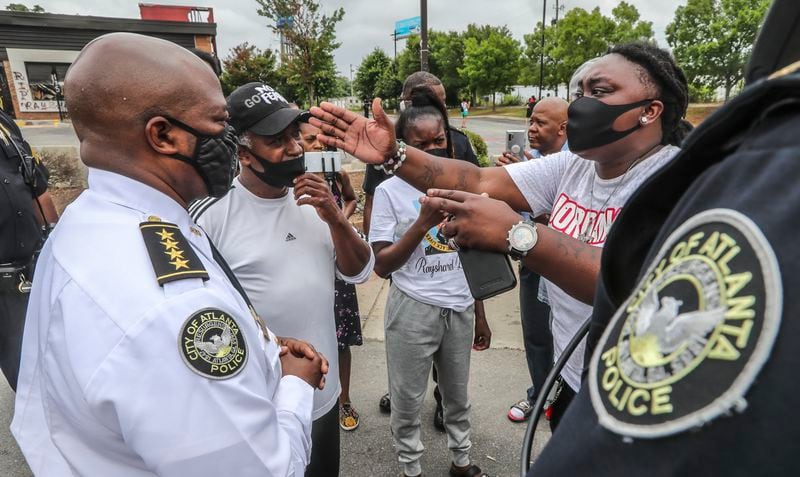July 6, 2020 Atlanta: Interim Atlanta Police Chief Rodney Bryant (left)  listens to a woman who identified herself as Lady A where Atlanta police and sanitation crews finished removing protesters and their belongings from outside the Wendy's on Monday, July 6, 2020, where Rayshard Brooks was shot and killed by an officer last month. The cleanup followed a violent holiday weekend that started Saturday night when 8-year-old Secoriea Turner was fatally shot while sitting in a car near the restaurant.  JOHN SPINK/JSPINK@AJC.COM