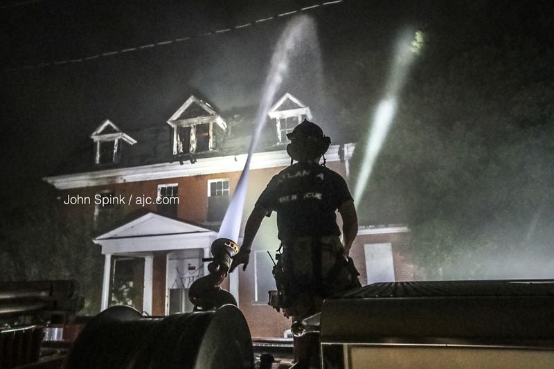 Firefighters continued to douse hot spots at the historic building Thursday morning. 