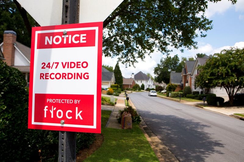 This sign greets people driving into neighborhoods with Flock Safety cameras.