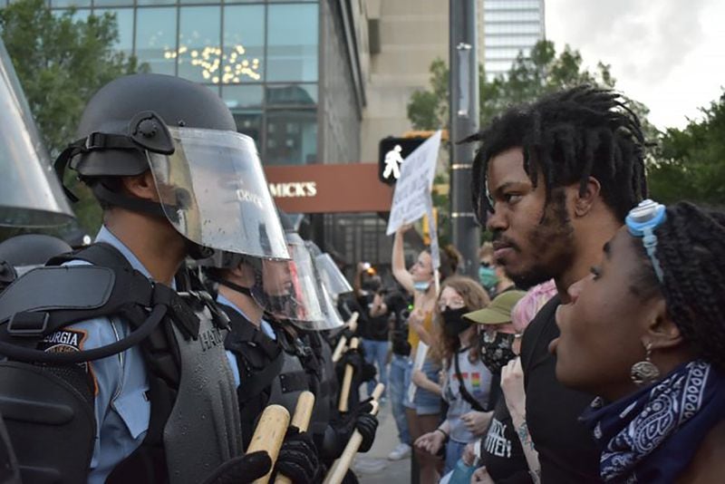 Police and protestors stared each other down next to CNN Center on Spring Street Friday evening. ROSS WILLIAMS / GEORGIA RECORDER