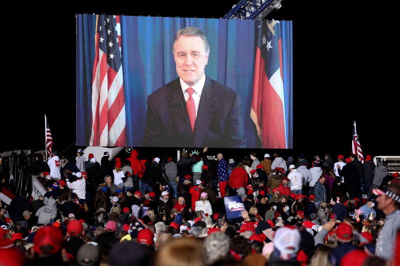 Republican incumbent Sen. David Perdue speaks via video monitor during a rally ahead of a Senate runoff in Dalton, Georgia on Monday, Jan. 4, 2021. (Sandy Huffaker/AFP/Getty Images/TNS)
