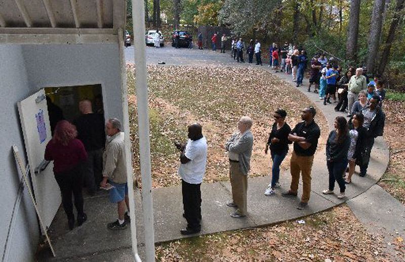 The line was long but moved quickly as voters waited to cast their ballots at Amazing Grace Lutheran Church in Lawrenceville on Tuesday. HYOSUB SHIN / HSHIN@AJC.COM